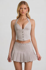 Low-Rise Pleated Mini Skirt in Ecru